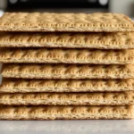 A timeline illustration showing the history and evolution of graham crackers from their original purpose to their modern use in desserts.