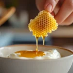 A person carefully cutting a piece of honeycomb, showing its golden honey-filled hexagonal structure and fresh appearance.